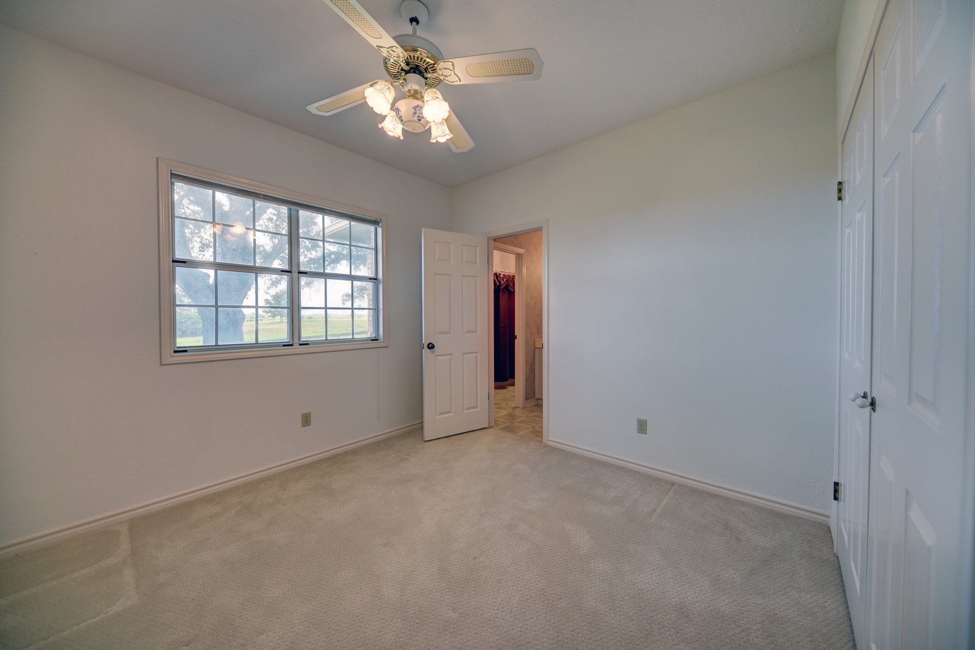 1552 Holub Road Schulenburg, TX 78956 - Photo 22 of 43 an empty room with chandelier fan and windows