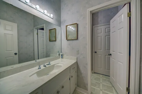 a bathroom with a double vanity sink and mirror
