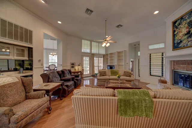 a living room with furniture fireplace and a table