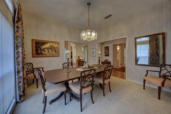 a view of a dining room with furniture and window