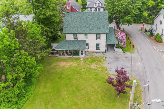 an aerial view of a house with swimming pool garden and patio
