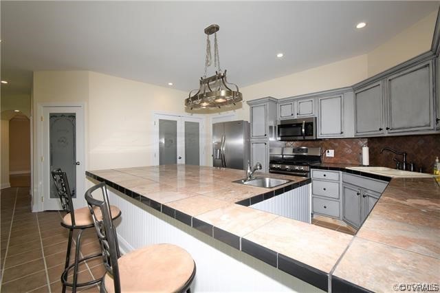 1629 Log Cabin Road Beaverdam, VA 23015 - Photo 17 of 40 a kitchen with stainless steel appliances granite countertop a sink a stove and cabinets