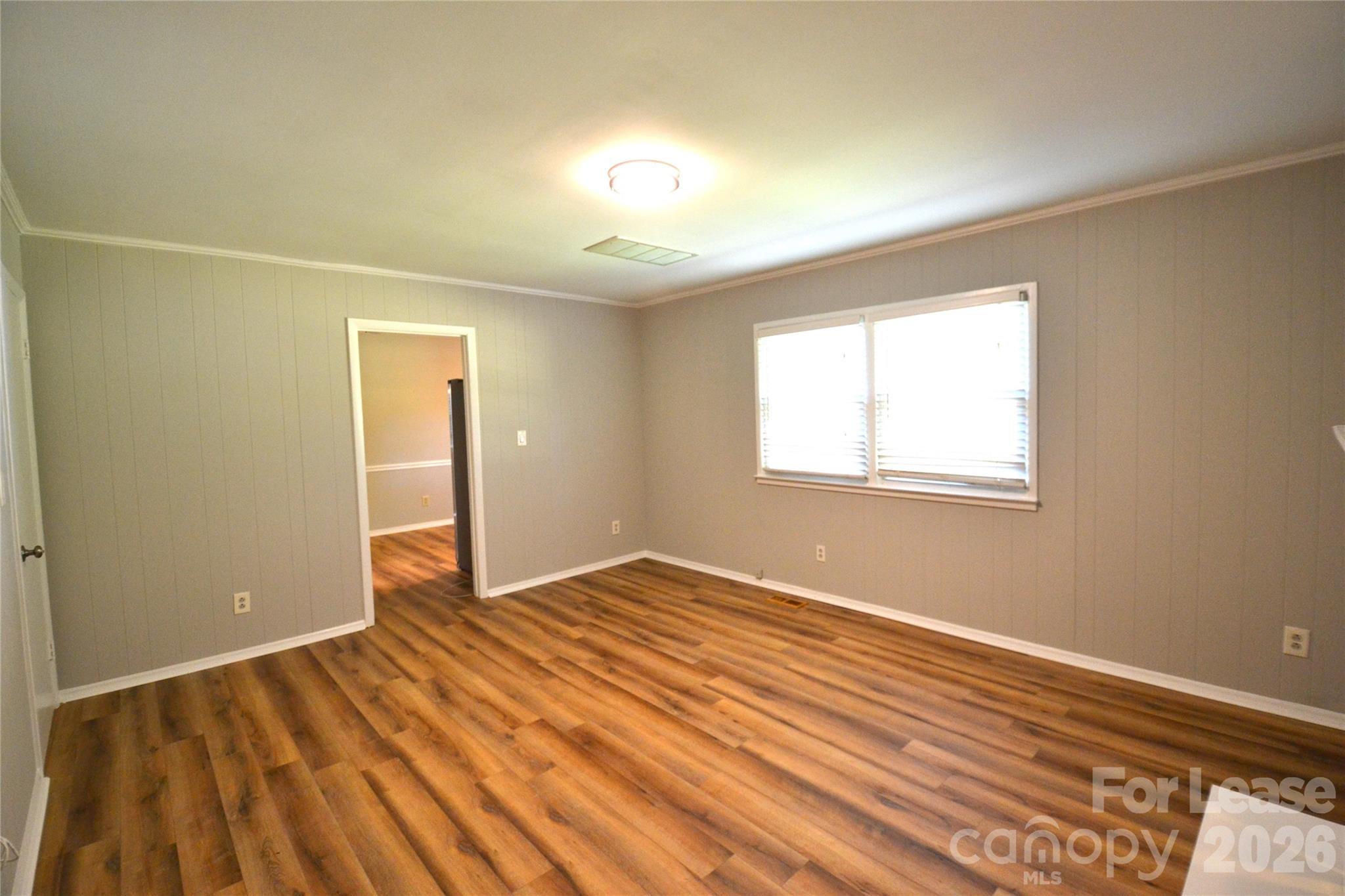 1422 Thermal Road Charlotte, NC 28212 - Photo 11 of 40 a view of an empty room with wooden floor and a window