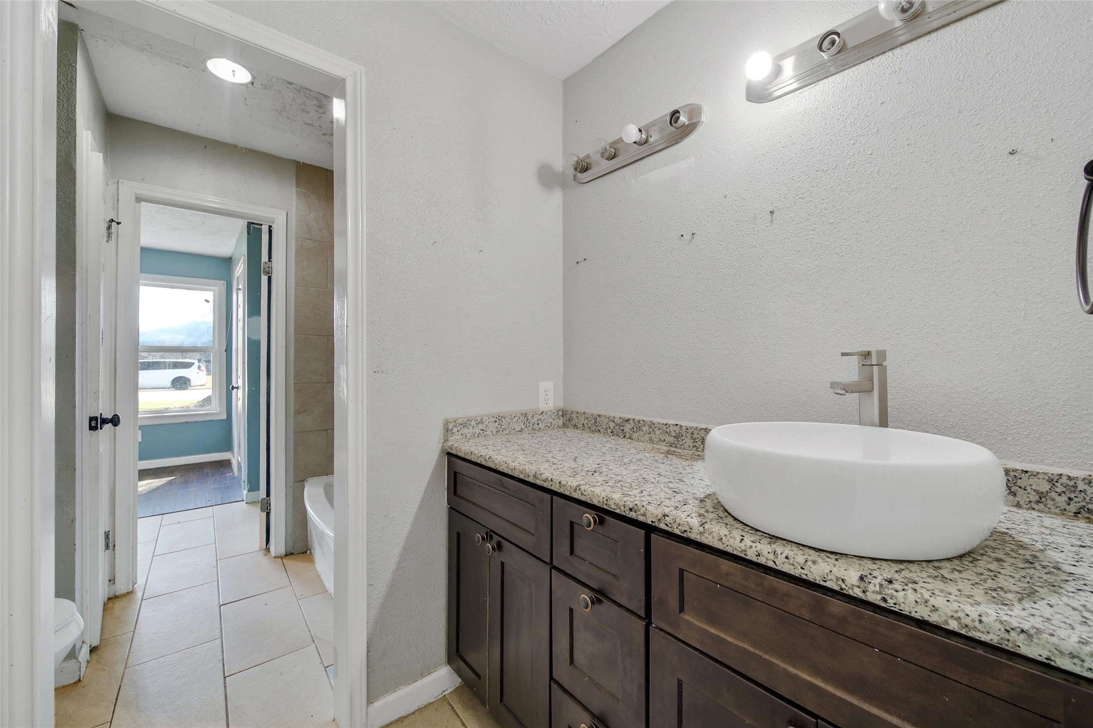 426 North Compass Rose Circle Crosby, TX 77532 - Photo 12 of 13 a en suite bathroom with a granite countertop sink and a mirror