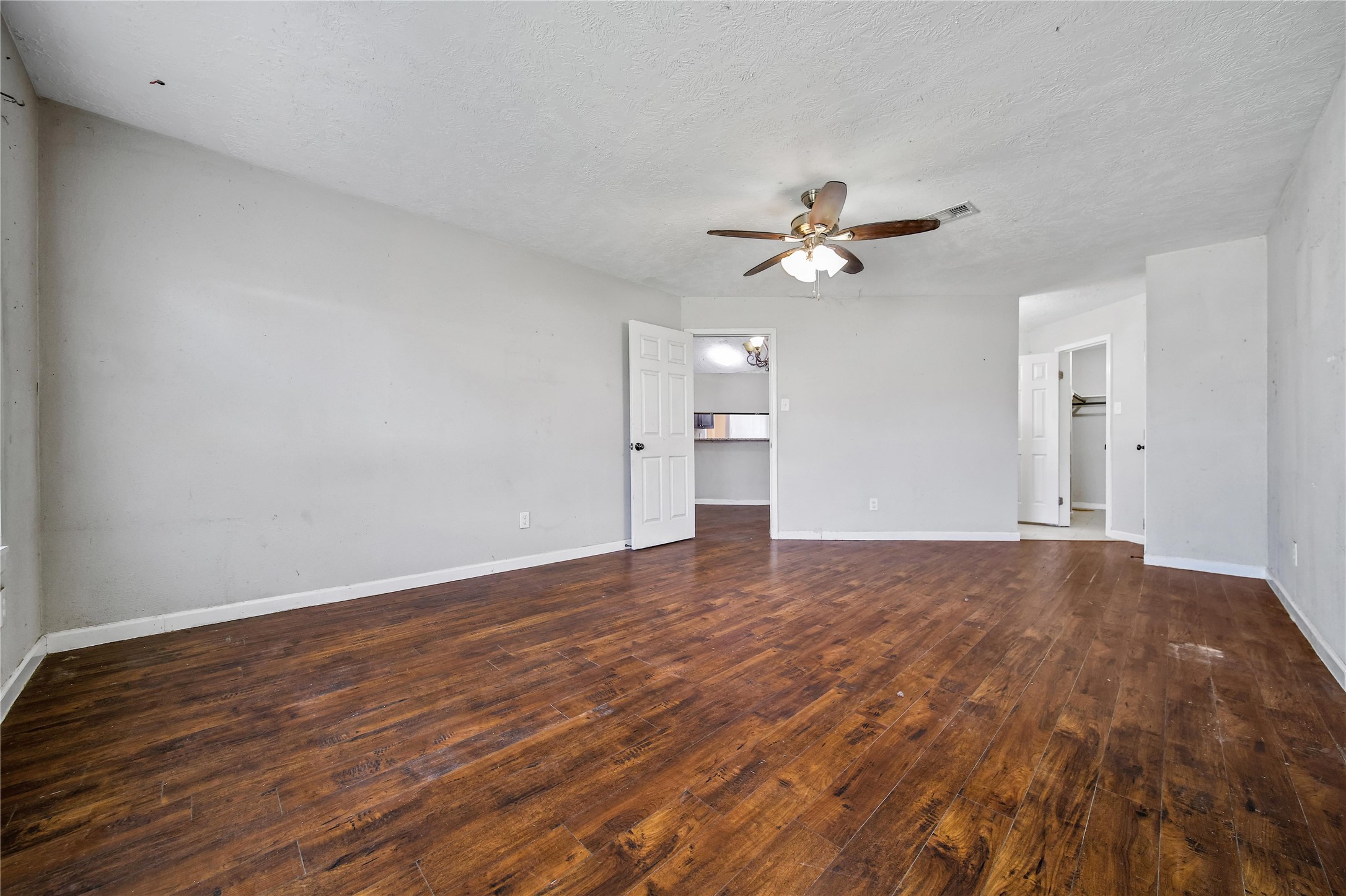 426 North Compass Rose Circle Crosby, TX 77532 - Photo 6 of 13 a view of empty room with wooden floor and a ceiling fan