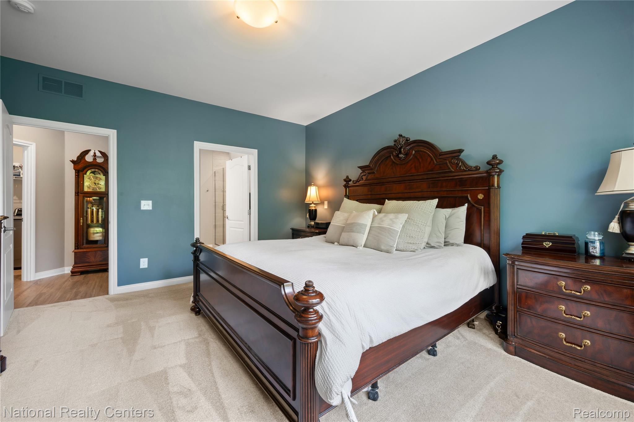 48796 Windfall Road Novi, MI 48374 - Photo 16 of 30 Bedroom featuring plush carpet flooring, blue accent walls, and a ceiling-mounted light fixture