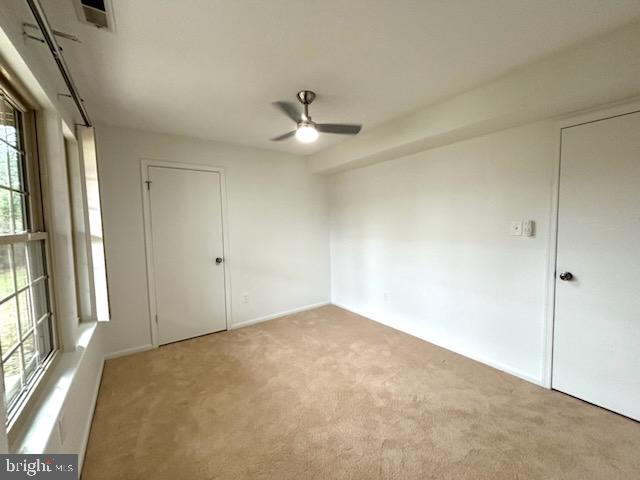 5 Neville Court Sewell, NJ 08080 - Photo 13 of 23 an empty room with a ceiling fan and a window