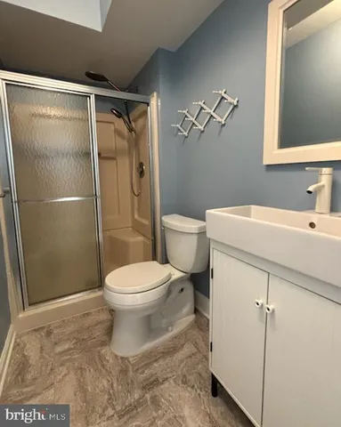 a bathroom with a sink toilet and shower