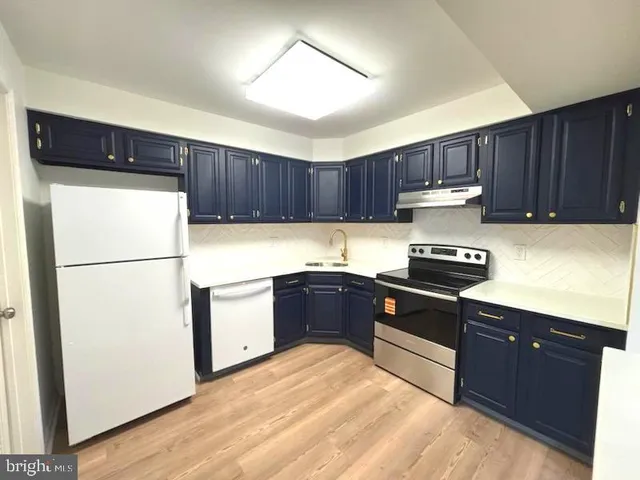 a kitchen with a refrigerator and a stove