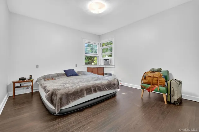 a bedroom with a bed a window and chair