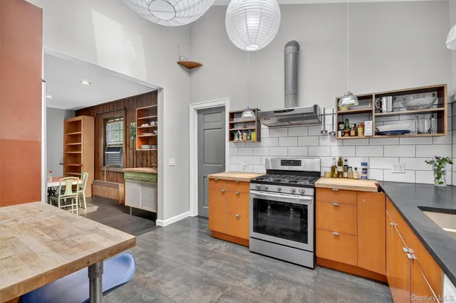 a kitchen with a stove and a wooden floors