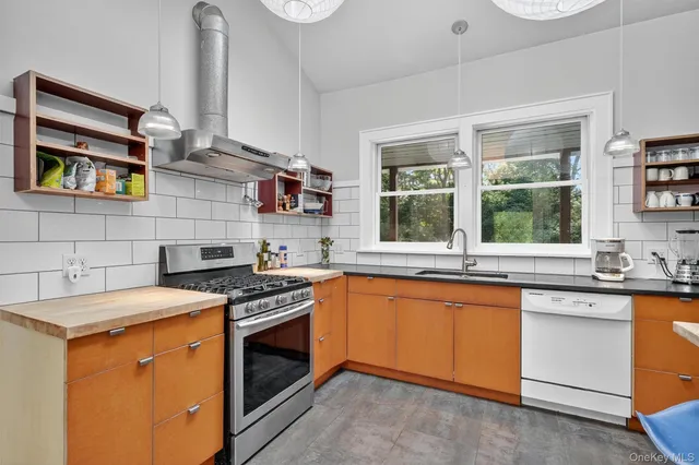 a kitchen with stainless steel appliances granite countertop stove top oven and sink