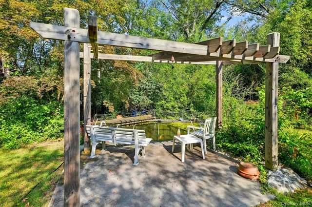 a view of a two chairs in the patio next to a yard