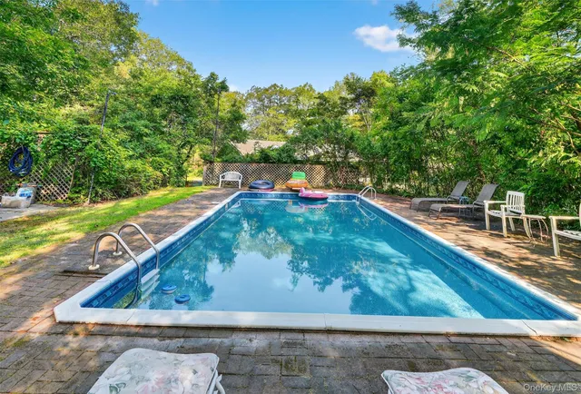 a view of a swimming pool with a yard