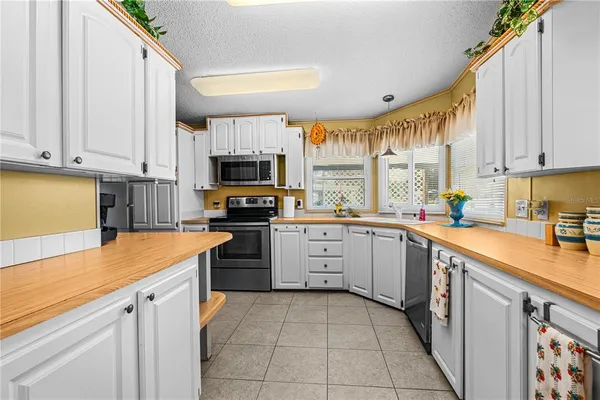 a kitchen with stainless steel appliances granite countertop a stove and a microwave