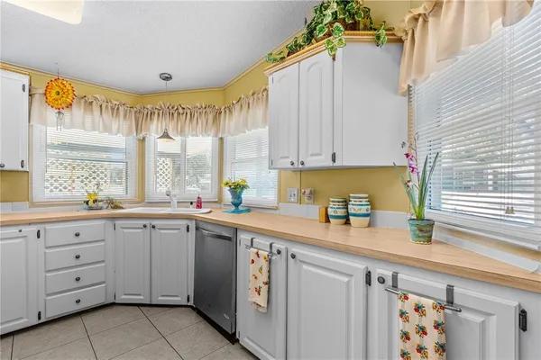 a kitchen with a sink window and cabinets