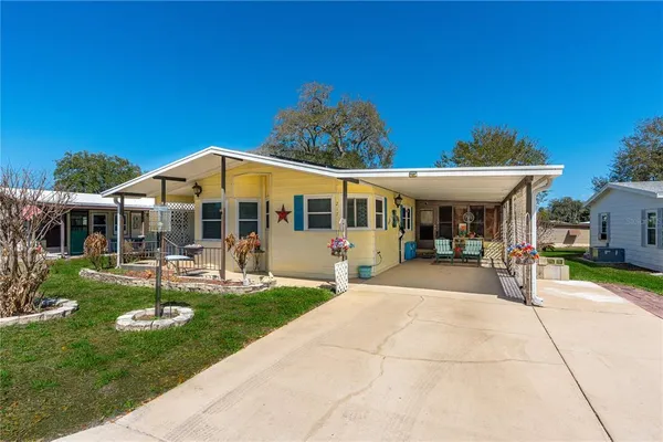 a view of a house with sitting area and garden