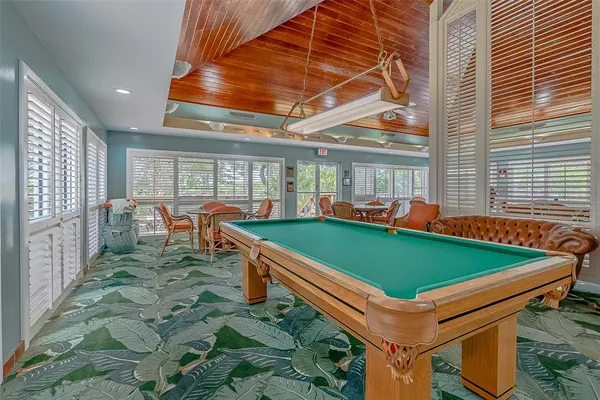 a gym room with lots of tables a large window and chairs