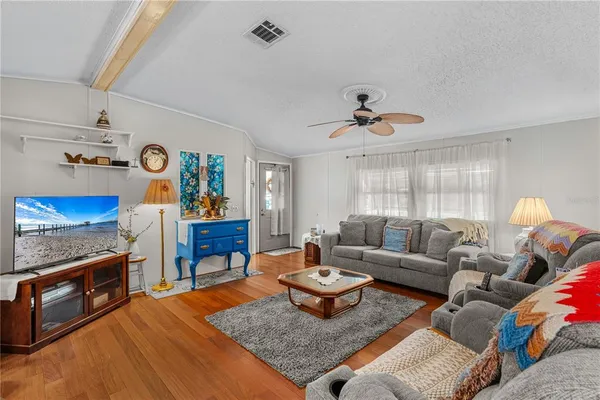 a view of a livingroom with furniture window and wooden floor