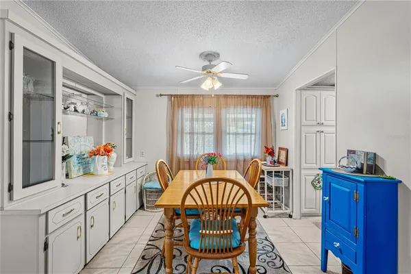 a kitchen with white cabinets and window