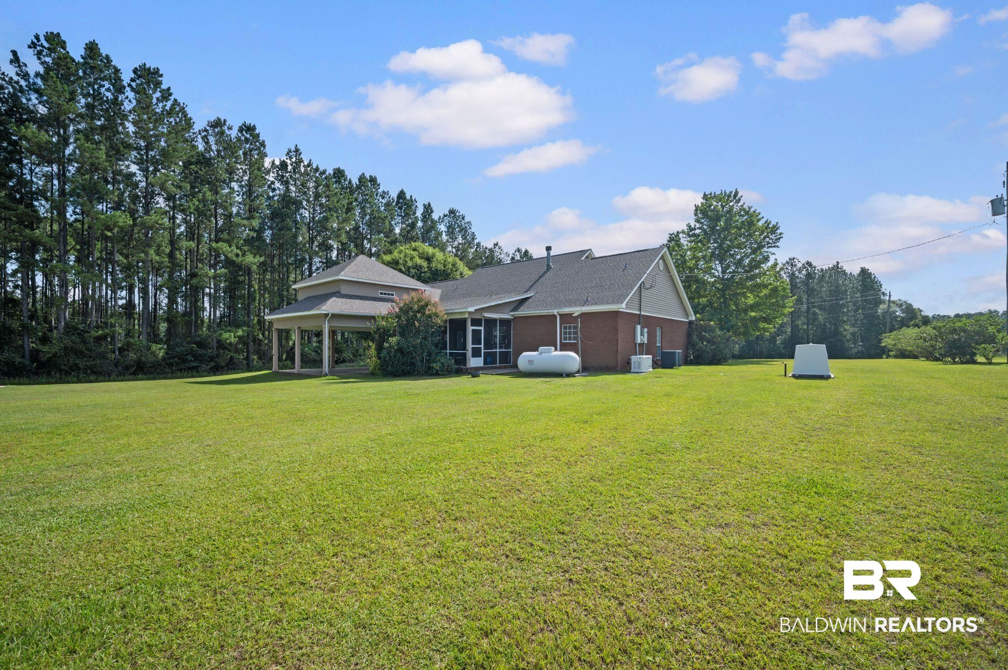 48513 Phillipsville Road Bay Minette, AL 36507 - Photo 46 of 50 View of home's exterior with a lawn, a gazebo, and roof with shingles