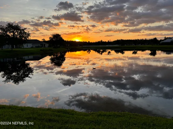 a view of a lake with a yard