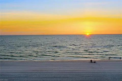 an aerial view of residential houses with outdoor space and ocean view
