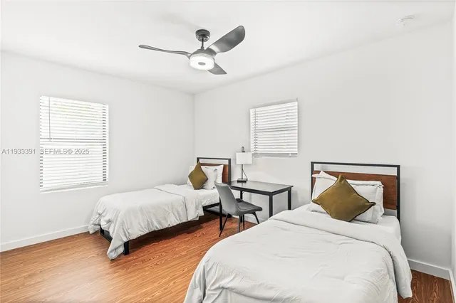 a bedroom with two beds and a window