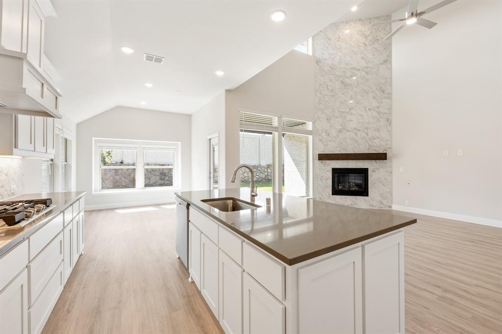 3512 Granite Rapids Road Mesquite, TX 75181 - Photo 16 of 40 a kitchen with granite countertop a sink stove and cabinets