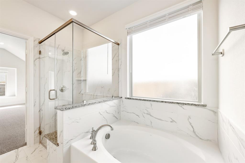 3512 Granite Rapids Road Mesquite, TX 75181 - Photo 24 of 40 a bathroom with a bathtub and a shower