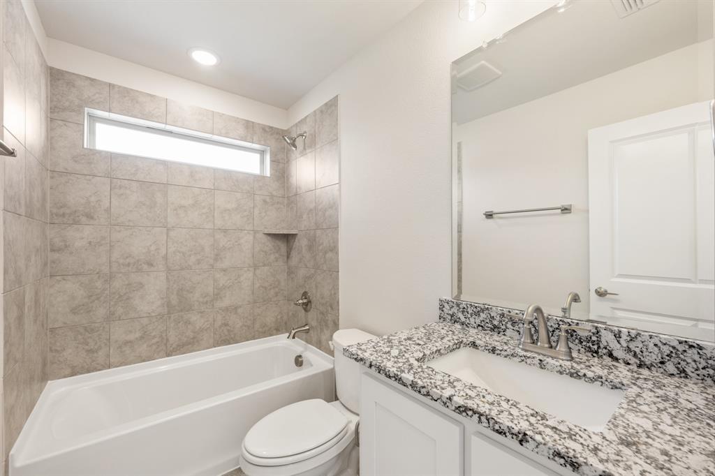 3512 Granite Rapids Road Mesquite, TX 75181 - Photo 31 of 40 a bathroom with a granite countertop bathtub shower sink vanity mirror and toilet