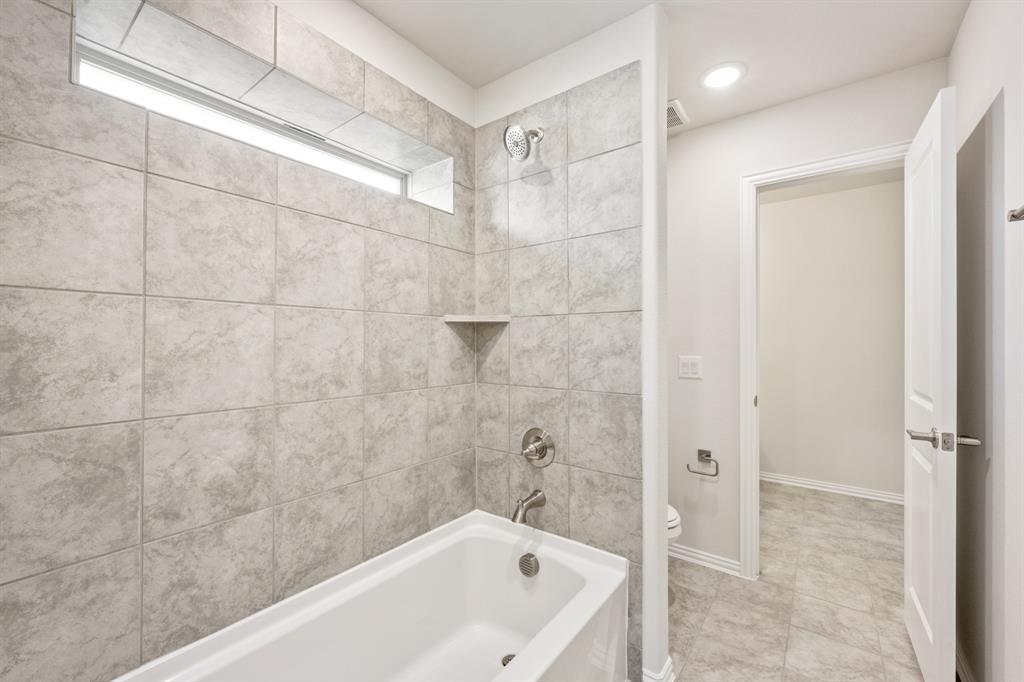 3512 Granite Rapids Road Mesquite, TX 75181 - Photo 34 of 40 a bathroom with a bathtub and shower