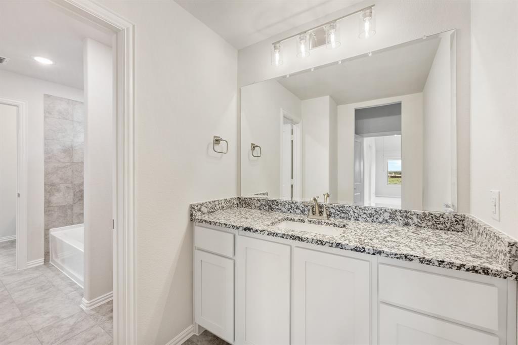 3512 Granite Rapids Road Mesquite, TX 75181 - Photo 35 of 40 a bathroom with a granite countertop sink and a mirror
