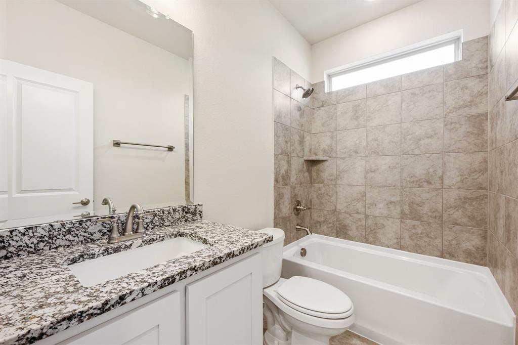 3512 Granite Rapids Road Mesquite, TX 75181 - Photo 7 of 40 a bathroom with a granite countertop sink a toilet and bathtub