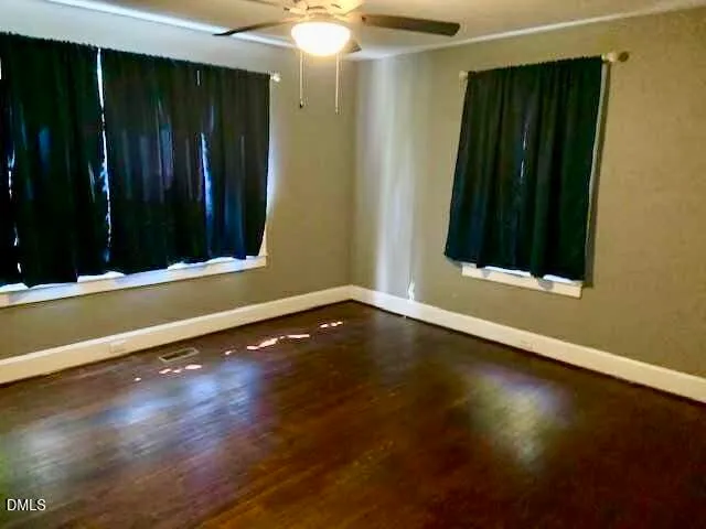 an empty room with wooden floor