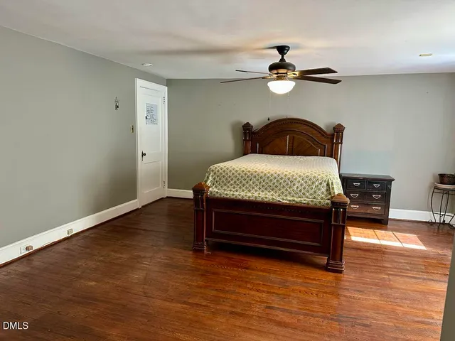 a bedroom with a bed and a ceiling fan