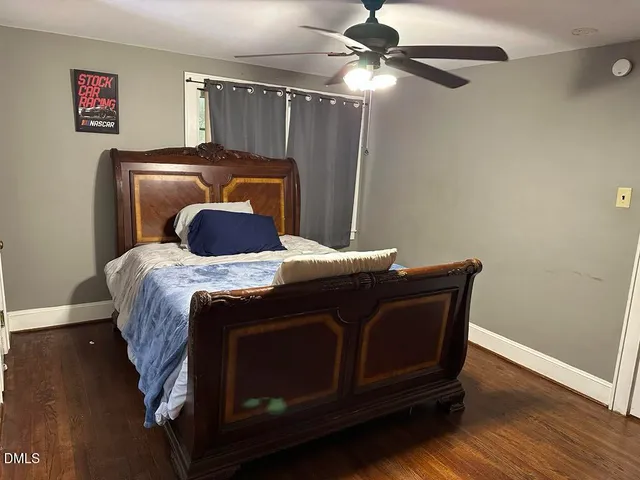 a bed sitting in a bedroom next to a window