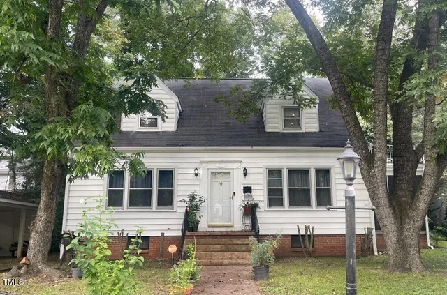 front view of a house with a tree