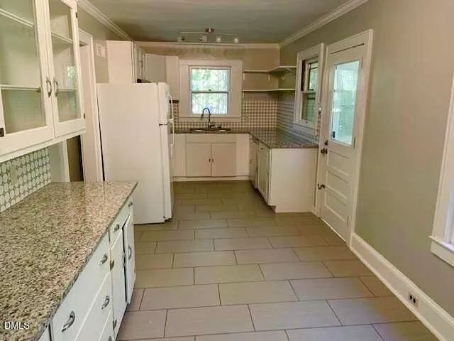 a kitchen with a sink stove and cabinets