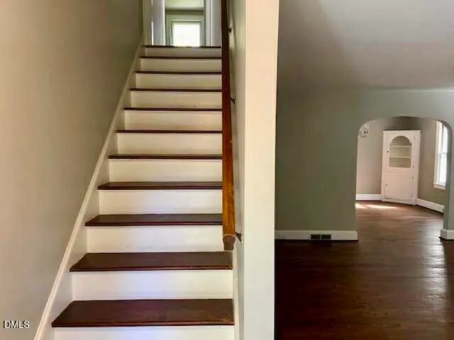 a view of entryway with wooden floor and front door