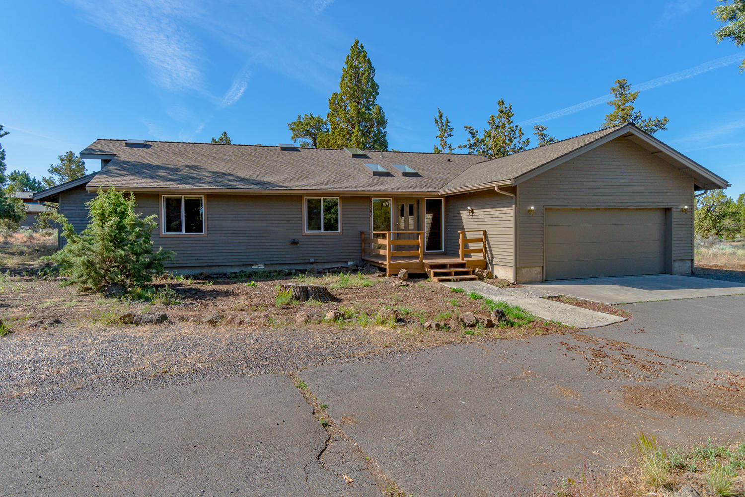 64597 McGrath Road Bend, OR 97701 - Photo 2 of 40 a view of a white house with a yard