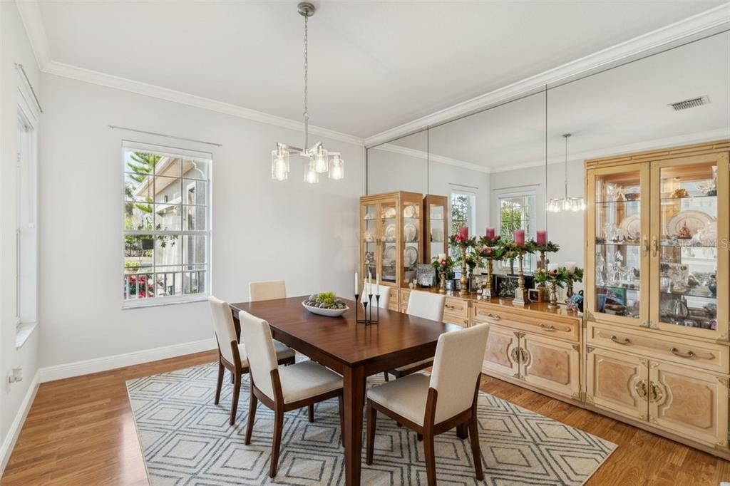 801 Glendora Road Kissimmee, FL 34759 - Photo 17 of 74 a dining room filled chandelier and wooden floor