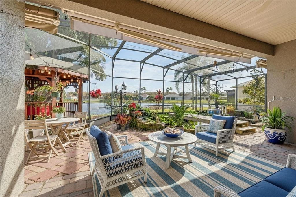 801 Glendora Road Kissimmee, FL 34759 - Photo 2 of 74 a view of a patio with a dining table and chairs with wooden floor