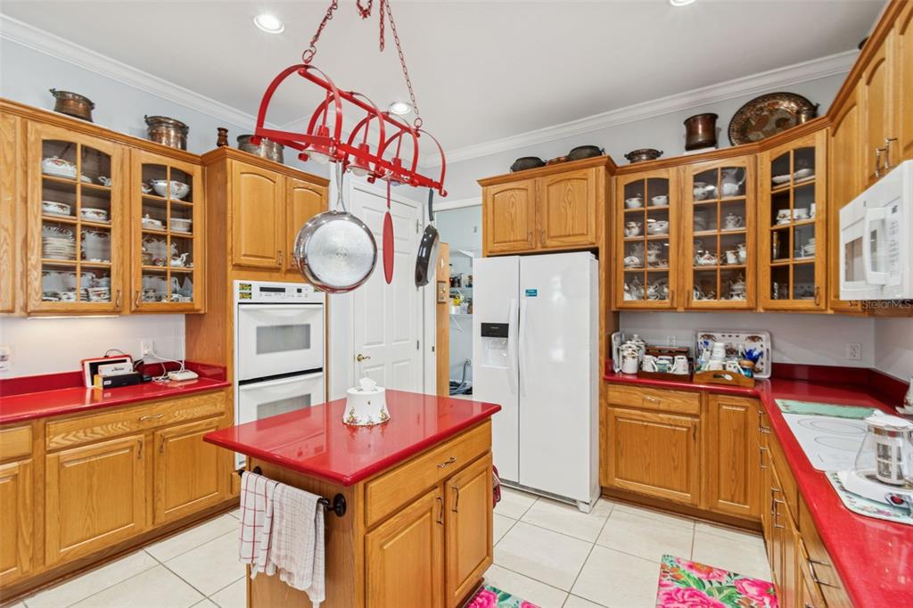 801 Glendora Road Kissimmee, FL 34759 - Photo 21 of 74 a kitchen that has a lot of cabinets a sink and a stove