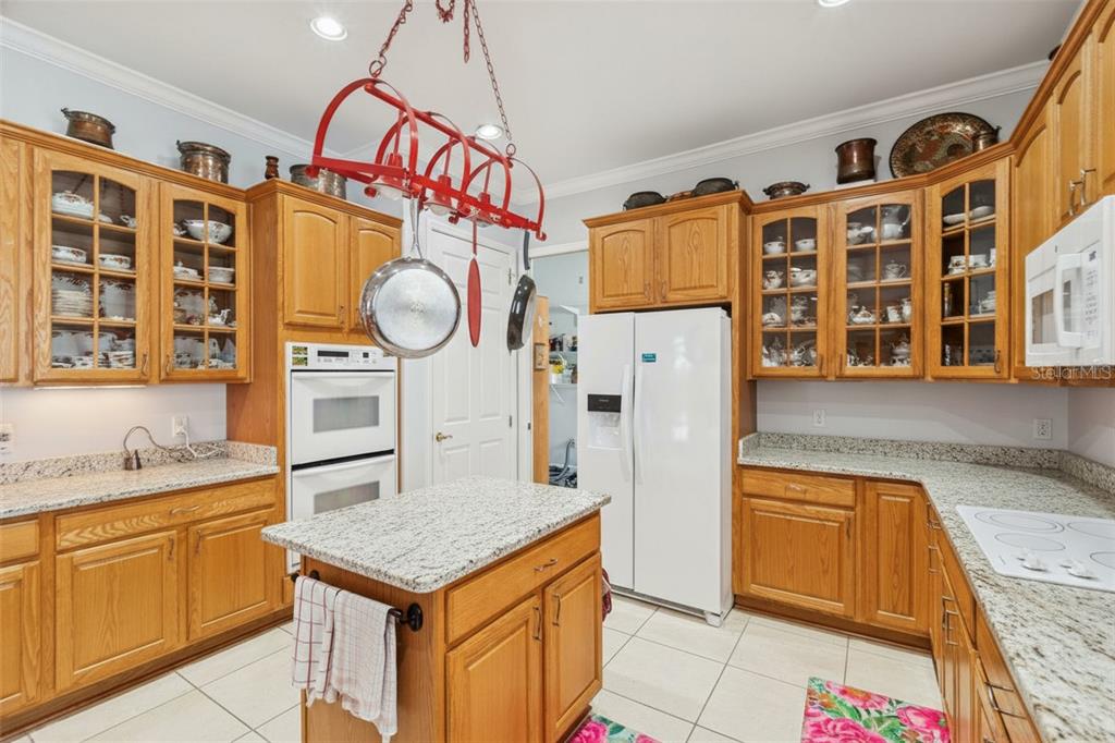 801 Glendora Road Kissimmee, FL 34759 - Photo 22 of 74 a kitchen with a refrigerator and a sink