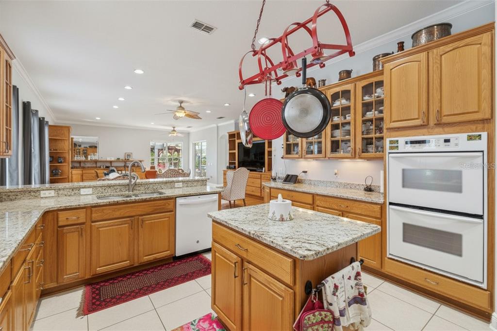 801 Glendora Road Kissimmee, FL 34759 - Photo 26 of 74 a kitchen with stainless steel appliances granite countertop a stove and cabinets