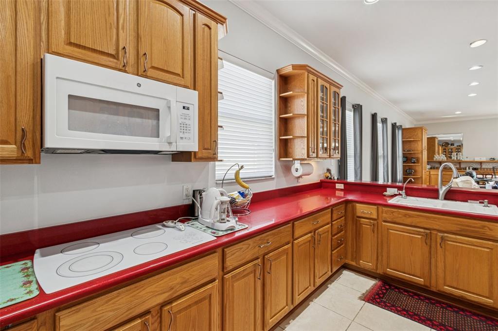 801 Glendora Road Kissimmee, FL 34759 - Photo 27 of 74 a kitchen with stainless steel appliances granite countertop a sink and cabinets
