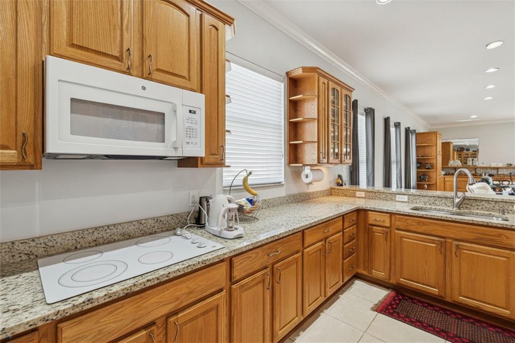 801 Glendora Road Kissimmee, FL 34759 - Photo 28 of 74 a kitchen with a sink and cabinets