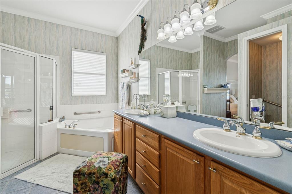 801 Glendora Road Kissimmee, FL 34759 - Photo 32 of 74 a bathroom with a sink double vanity granite tub and a mirror