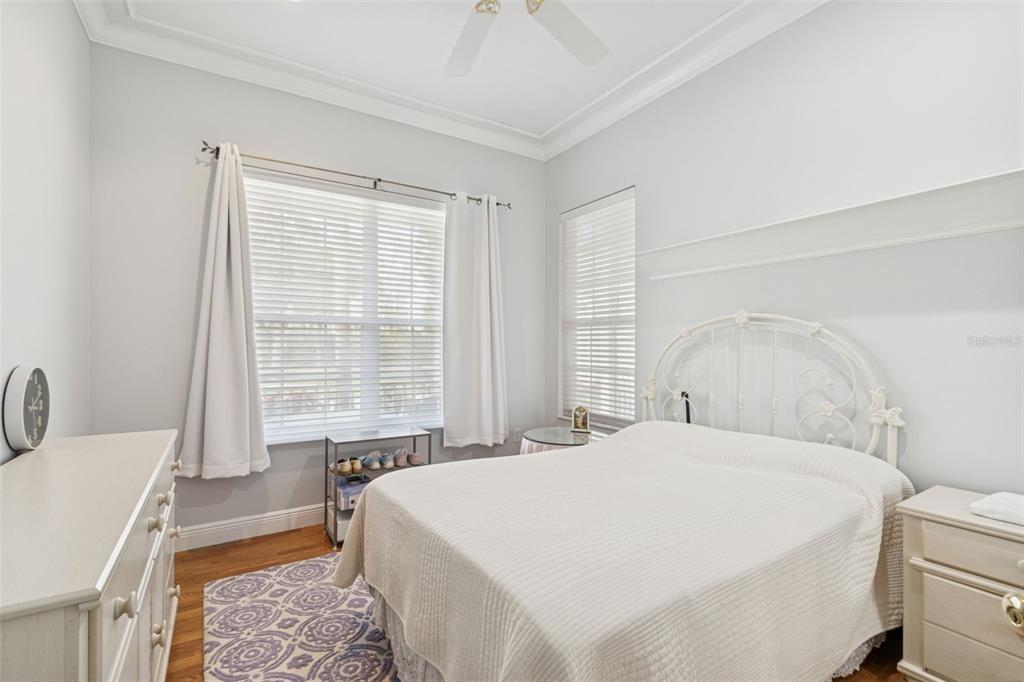 801 Glendora Road Kissimmee, FL 34759 - Photo 38 of 74 a spacious bedroom with a bed a couch and a window